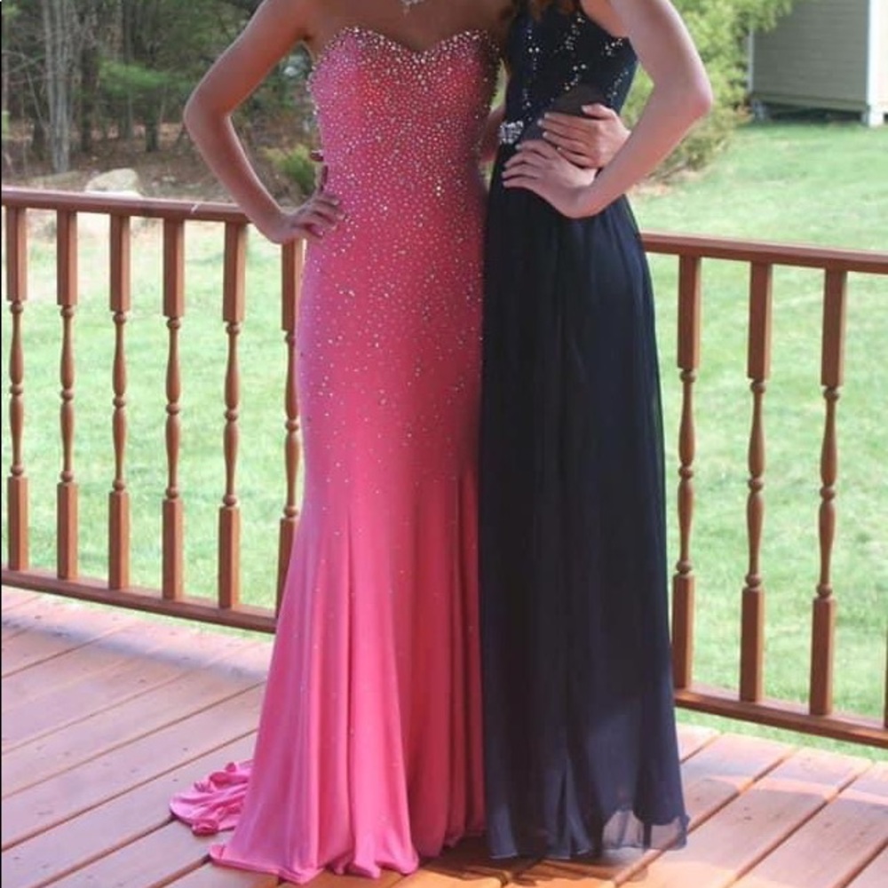 Jeweled form fitting prom dress with long train.